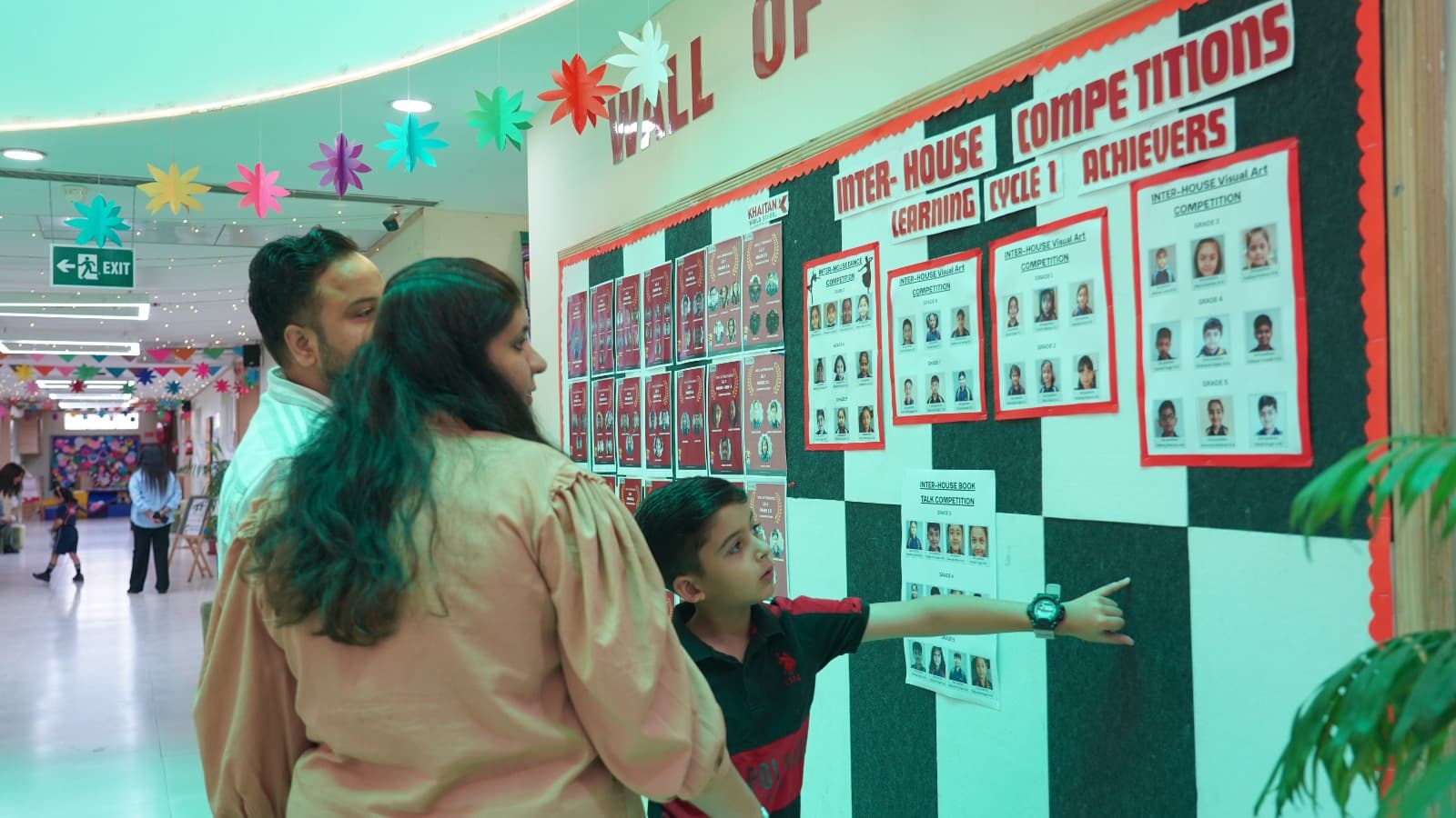 Together, parents and children wander through school exhibitions